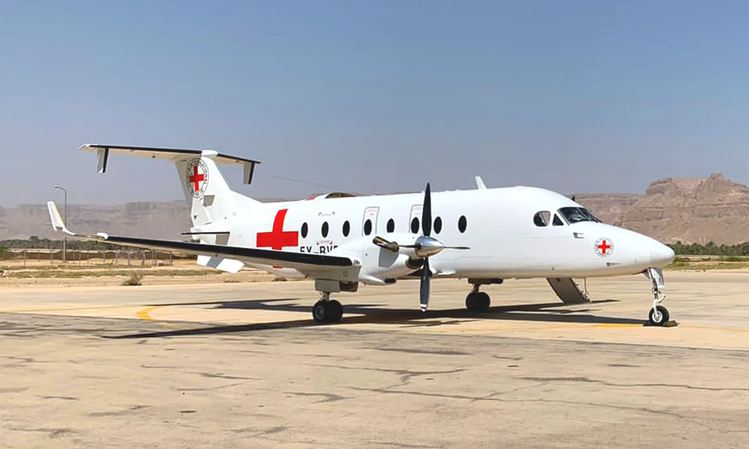 An ALS Beechcraft 1900D in ICRC colours on a desert apron