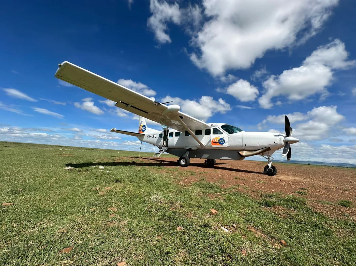 A Fly ALS Grand Caravan on a grass airstrip