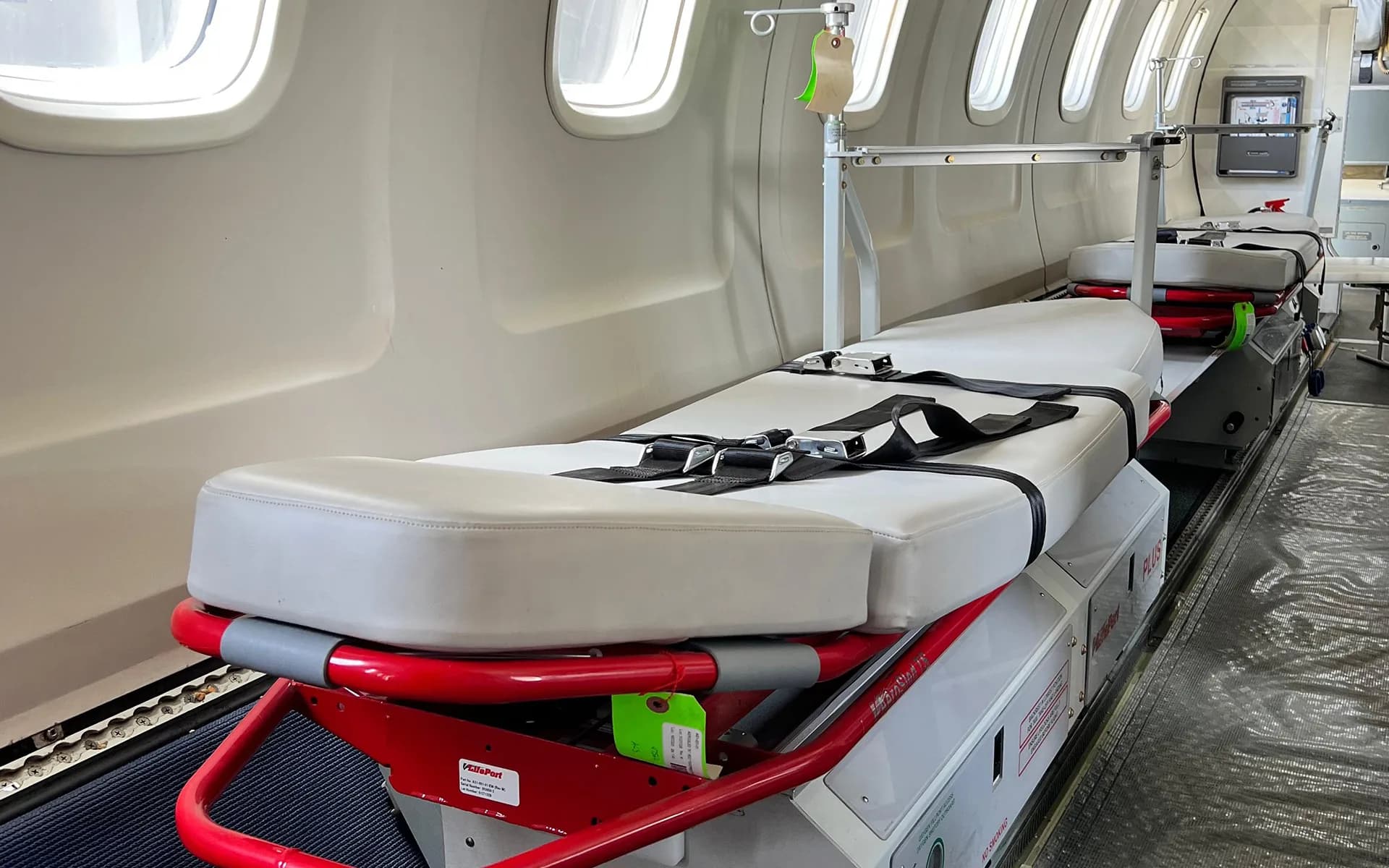 Two stretchers fitted along the left side of an ALS ERJ-145 air ambulance cabin